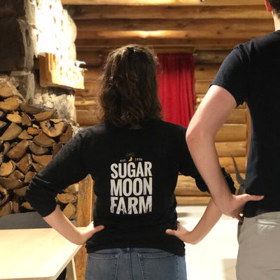 Long sleeve t-shirt with Sugar Moon Farm logo on back. Farm a Canadian maple syrup farm located in Nova Scotia, Canada. Offering maple syrup, maple butter, maple syrup on snow, and a restaurant. Put on your hiking boots and hike Rogart Mountain trail then sit down for some fluffy pancakes made from our fluffy pancake recipe and Canadian maple syrup.