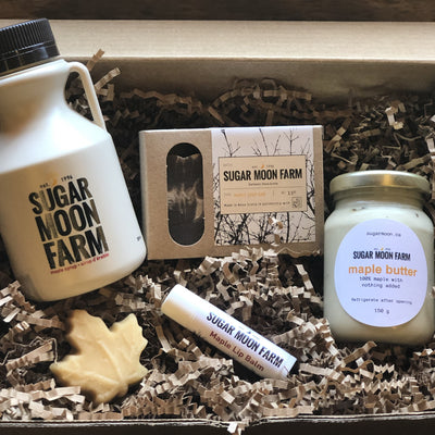 Maple Everything Box - 250ml jug of Sugar Moon Maple Syrup, bar of Sugar Moon Maple Soap, stick of Sugar Moon Lip Balm, jar of delectable Sugar Moon Maple Butter. a Canadian maple syrup farm located in Nova Scotia, Canada. Offering maple syrup, maple butter, maple syrup on snow, and a restaurant. Put on your hiking boots and hike Rogart Mountain trail then sit down for some fluffy pancakes made from our fluffy pancake recipe and Canadian maple syrup.