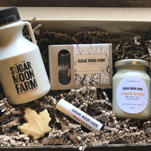 Maple Everything Box - 250ml jug of Sugar Moon Maple Syrup, bar of Sugar Moon Maple Soap, stick of Sugar Moon Lip Balm, jar of delectable Sugar Moon Maple Butter. a Canadian maple syrup farm located in Nova Scotia, Canada. Offering maple syrup, maple butter, maple syrup on snow, and a restaurant. Put on your hiking boots and hike Rogart Mountain trail then sit down for some fluffy pancakes made from our fluffy pancake recipe and Canadian maple syrup.